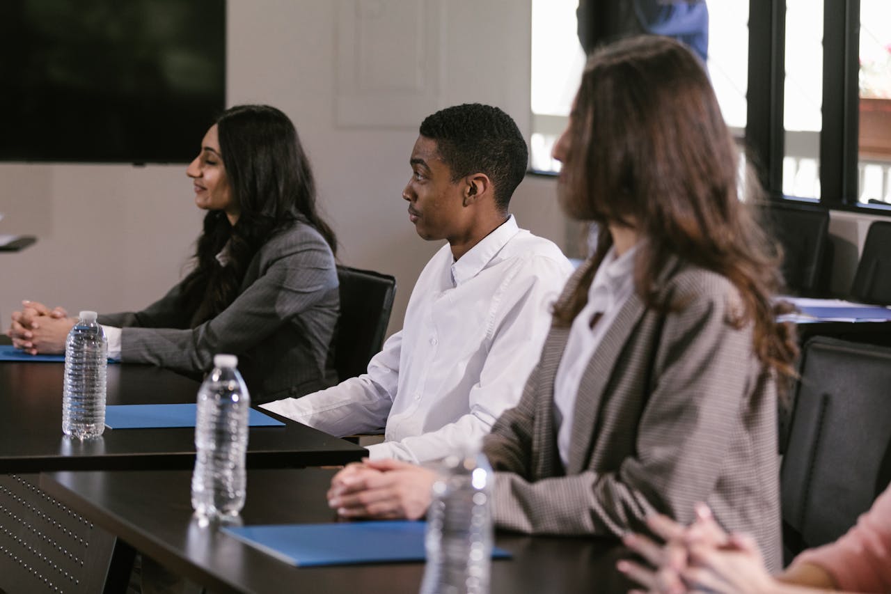 Diverse professionals attending a meeting in a modern conference room.